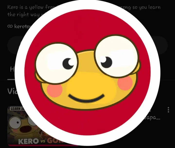 A redrawn Kero channel icon: a golden frog face with large round eyes, pink cheeks and a broad smile, centred on a deep red circle inside a thick white ring, captured against the channel page.