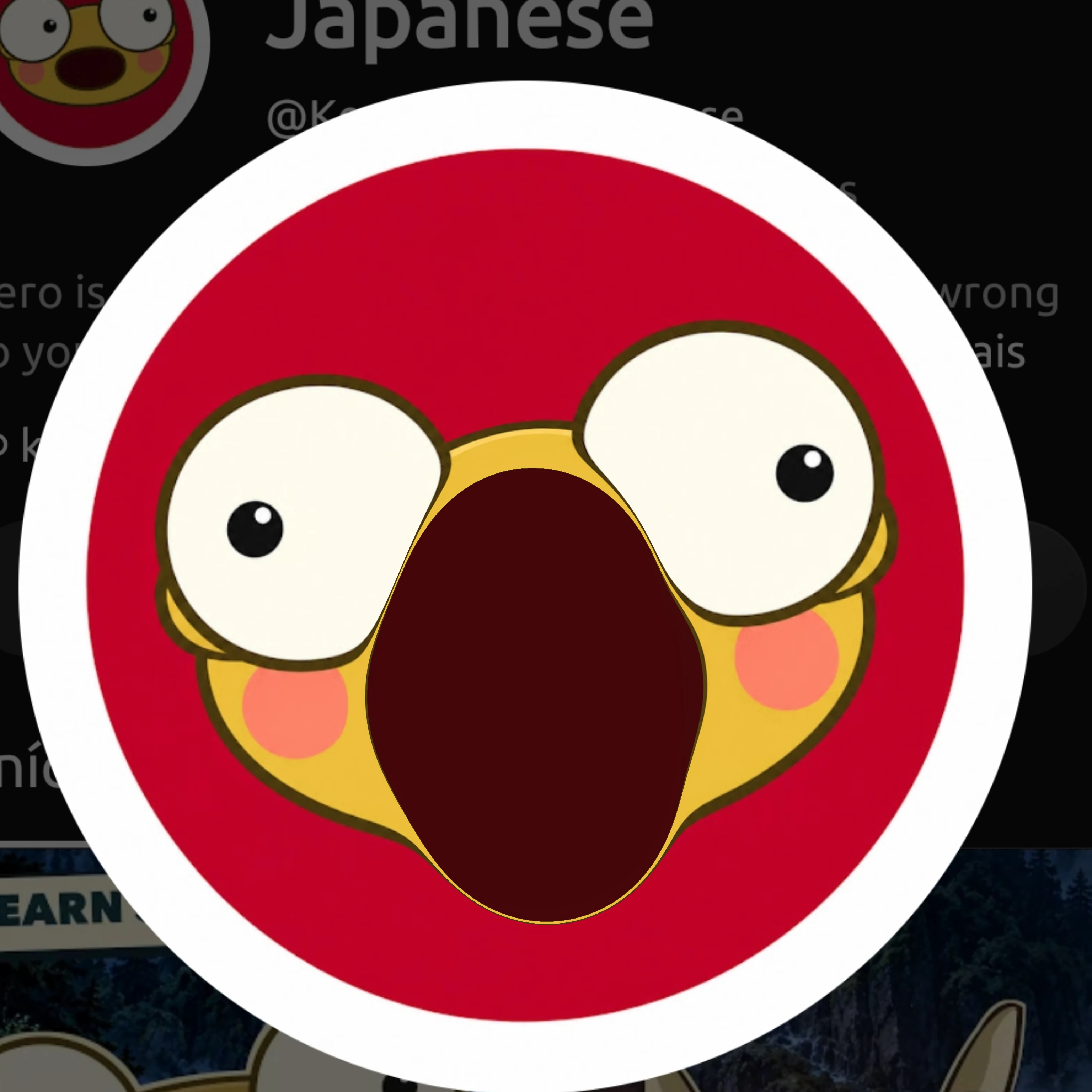 The channel’s round red Kero profile picture in a thick white ring fills most of the picture: a golden Kero with big cream eyes looking different ways and pink cheeks, his mouth stretched into a huge tall dark red oval that runs from between his eyes down past his chin. Behind it, a darkened screenshot of the Kero Learns Japanese channel page shows the small profile picture in the top left corner, part of the channel name and handle in grey, scraps of the channel description and, along the bottom, part of a darkened picture of a forest, with a sign whose visible letters read EARN and the tops of a cartoon character’s big round eyes.